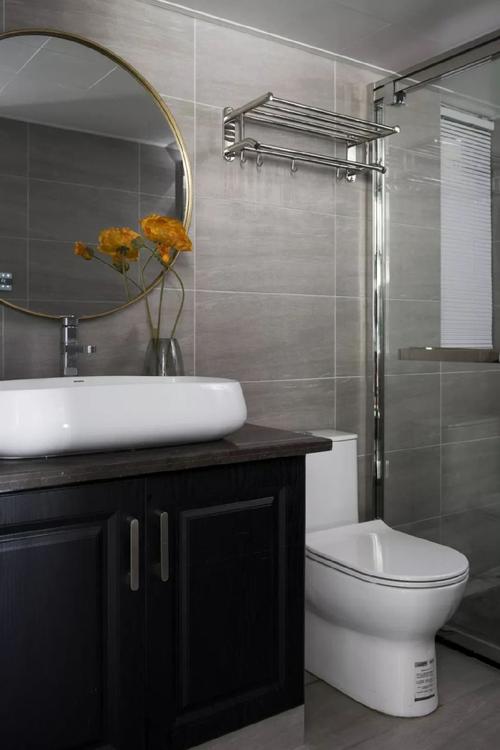 卫生间做了干湿分离的设计灰色瓷砖搭配白色洗手盆整体风格相互呼应.