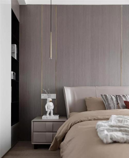 床头背景与客厅沙发墙一样以木饰面板做硬包再加入金色的线条优雅大气