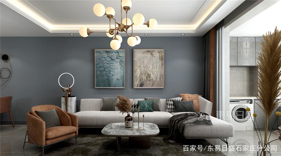 沙发墙以灰蓝色为背景搭配两幅挂画让客厅氛围显得现代时尚而又年轻