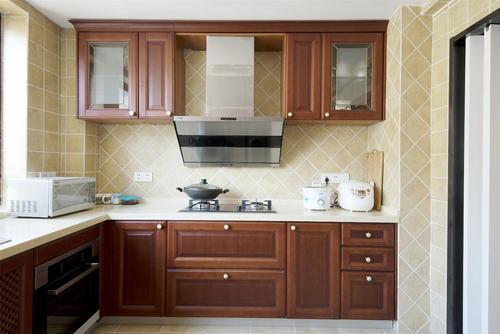 厨房厨房选用咖啡色整体橱柜配以金属质感的现代化电器大气又